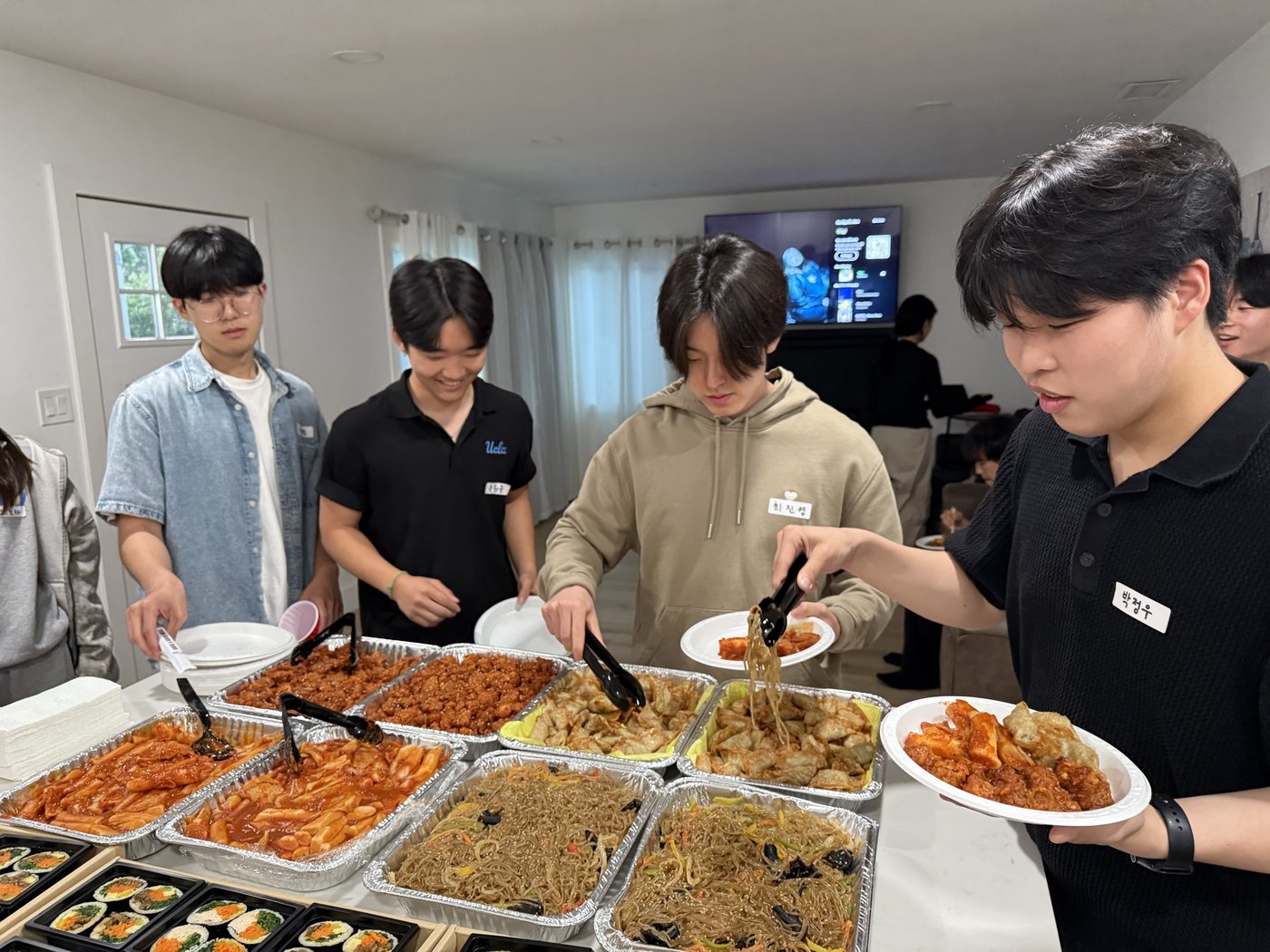 Students serving Korean food at a campus event